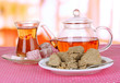 Photo: Tasty halva with tea on table in room Tasty halva with tea on table in room