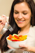 Cute woman eating fresh bowl of vegetables