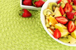 Useful fruit salad of fresh fruits and berries in bowl