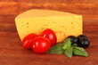 Cheese,basil and vegetables on wooden background