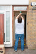 Photo: Man sanding down the front door Man sanding down the front door