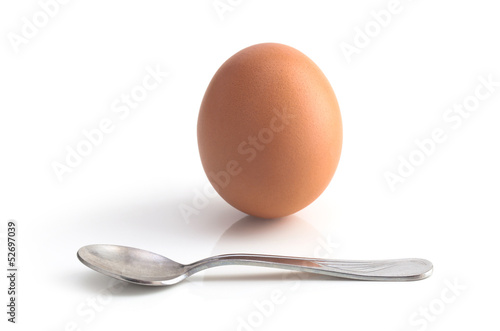 Photo: egg and spoon on white background egg and spoon on white background