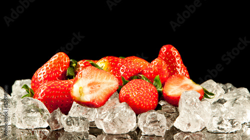 Photo: strawberry on black background. strawberries with ice cubes on strawberry on black background. strawberries with ice cubes on