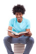 Young black teenage student men reading a books - African people