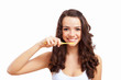 Young woman at home brushing teeth