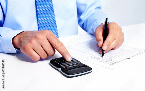 Photo: Hand with calculator. Hand with calculator.