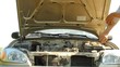 Man troubleshoot a broken car under the hood  