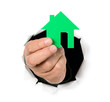 Man is showing house shape through a hole
