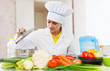Cook looks into the pan