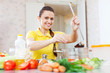  young woman salts the soup