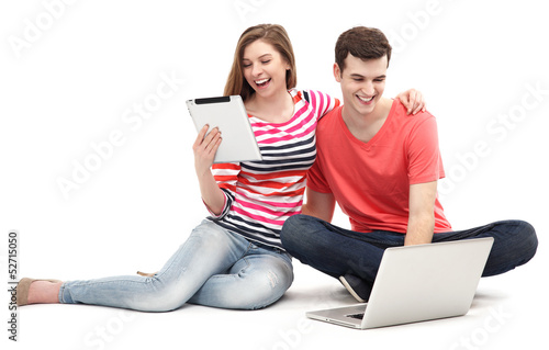 Photo: Couple with laptop and digital tablet Couple with laptop and digital tablet