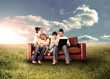 Happy family using the laptop in a field