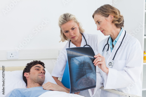 Photo: Doctors showing radiography to a patient Doctors showing radiography to a patient