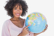 Happy woman pointing to globe