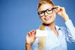 Businesswoman holding credit card. Isolated on blue