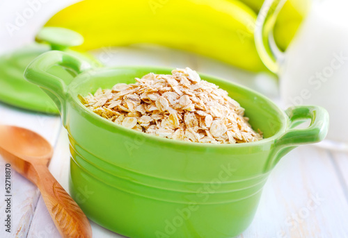 Photo: Oat flakes in the green bowl with banana and milk Oat flakes in the green bowl with banana and milk