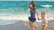 mother and son running on the beach