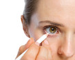 Photo: Closeup on woman using white eye liner Closeup on woman using white eye liner