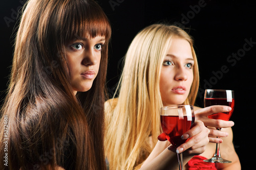 Photo: Two young women drinking red wine Two young women drinking red wine