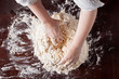 Hands preparing pizza dough
