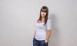 Photo: pretty girl standing in front of wall pretty girl standing in front of wall