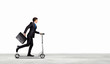 Businessman riding scooter
