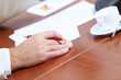 Hands of businessman laying on table