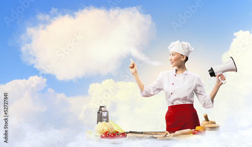 Photo: Asian female cook holding megaphone Asian female cook holding megaphone
