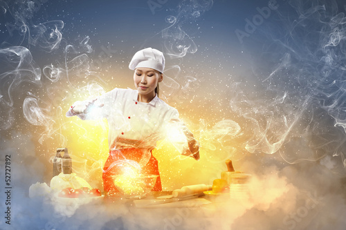 Photo: Asian female cooking with magic Asian female cooking with magic