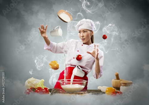 Photo: Asian female cooking with magic Asian female cooking with magic