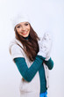 Photo: Young woman wearing winter hat and warm scarf Young woman wearing winter hat and warm scarf