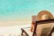 Young woman reading a book at beach