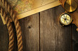Photo: Antique compass and rope over old map Antique compass and rope over old map