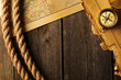 Photo: Antique compass and rope over old map Antique compass and rope over old map