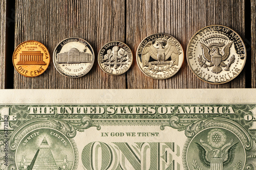 Photo: US money over wooden background US money over wooden background