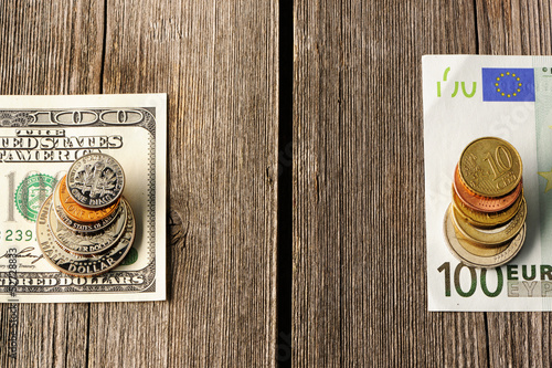 Photo: US and euro money over wooden background US and euro money over wooden background