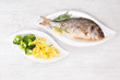 Photo: Grilled sea bream with potatoes on plate. Grilled sea bream with potatoes on plate.