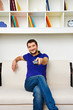 man resting on sofa and watching tv