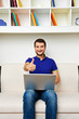 smiley man working with laptop