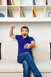 man sitting on sofa and watching tv