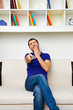 man watching tv and yawning