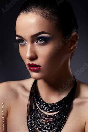 Photo: beautiful model with bright makeup with accessories in studio beautiful model with bright makeup with accessories in studio