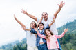 Happy family with arms up