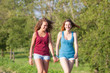 Two Beautiful Teenage Girls Walking at Park