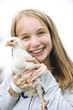 Foto: Teenage girl holding chicken Teenage girl holding chicken