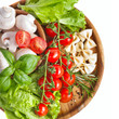Fresh cherry tomatoes and salad in a wooden plate