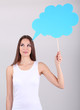 Young pretty woman with empty think bubble on grey background