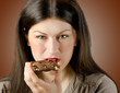 Photo: Young woman with with a chocolate bar Young woman with with a chocolate bar