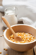 Wooden bowl and a small jug on the wooden background