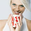 Close-up portrait of a  smiling and holding a mug